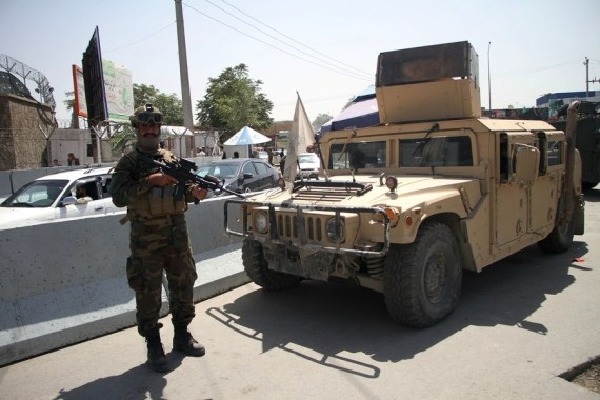 Taliban fighters force men into car boots