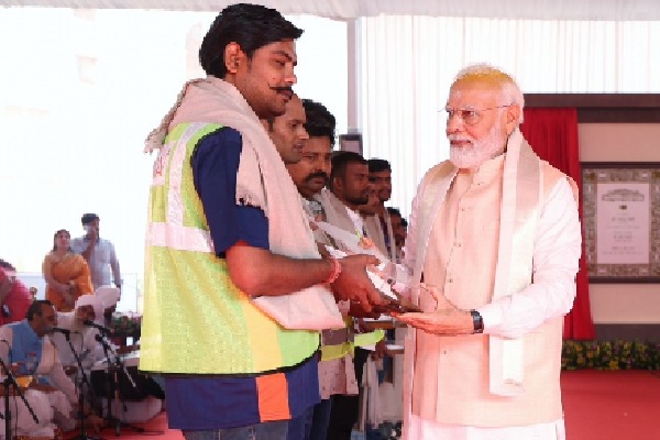 PM Modi felicitates workers involved in making of new Parliament House