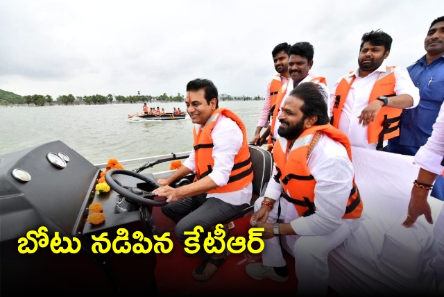 KTR drives a boat in Mid Maneru Reservoir 