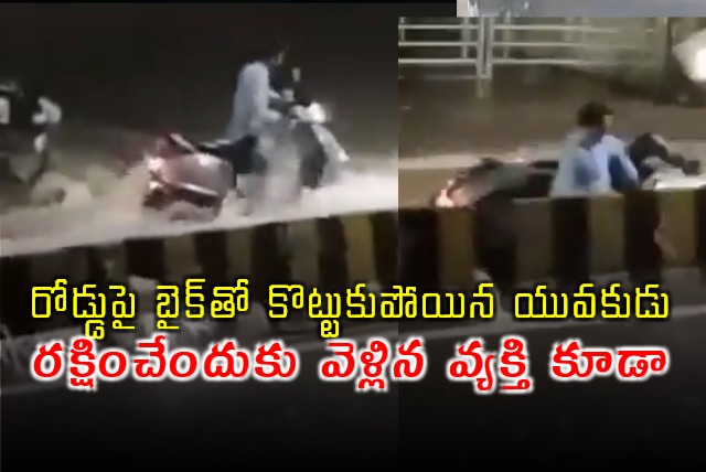 Young man washed away in rain water with his bike in Hyderabad