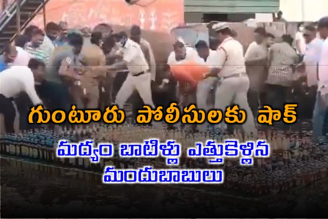 Andhra cops line up liquor bottles for disposal locals grab and run off